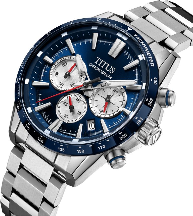 Solvil et Titus Saber Chronograph W06-03401-003 — angled view showing blue tachymeter bezel, white chronograph centre second hand, crown engraved with the saber-toothed tiger's tooth symbol and blue accent, and 24-hour subdial